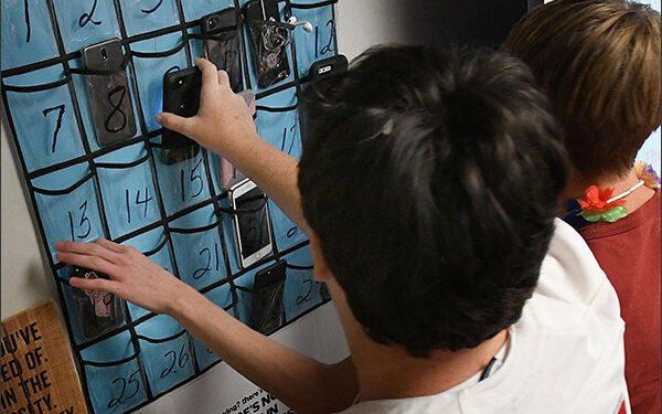 Minerva High School students grab their cellphones on the way out the door at the end of teacher Julie Holderbaum's English class. (CantonRep.com / Ray Stewart)