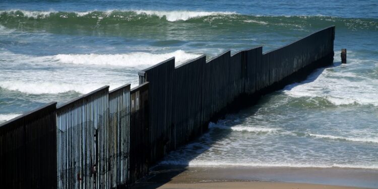 The border fence between the United States and Mexico reaches its most westerly point an ends into the Pacific Ocean at Border Field State Park near San Diego, California, U.S., April 30, 2017. REUTERS/Mike Blake