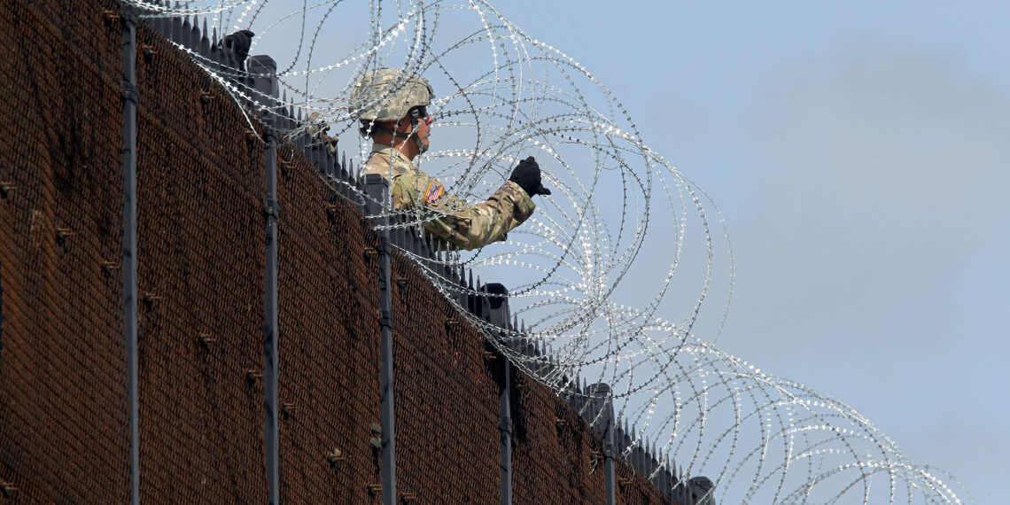 REFILE - CORRECTING THE TYPE OF THE WIRE U.S. Army soldiers install a razor wire fence along Anzalduas International Bridge near the U.S.- Mexico border in McAllen, Texas,  November 5, 2018. REUTERS/Delcia Lopez