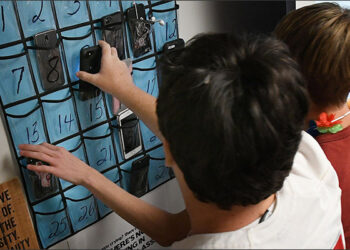 Minerva High School students grab their cellphones on the way out the door at the end of teacher Julie Holderbaum's English class. (CantonRep.com / Ray Stewart)