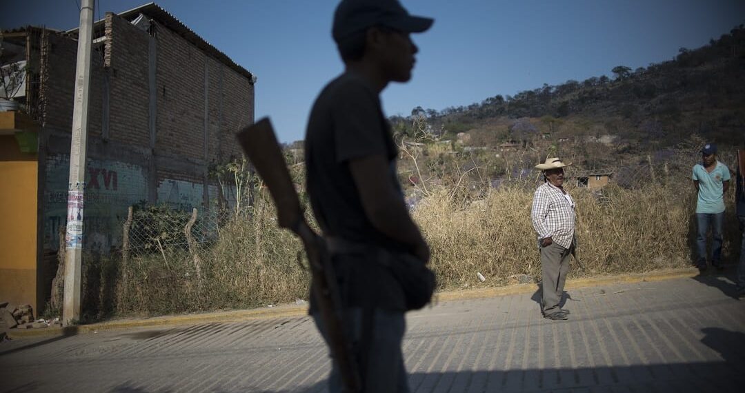 A Guerrero Community Police member stands guard in Tlacotepec, Heliodoro Castillo municipality, Guerrero state, Mexico, on March 24, 2018. - In the mountainous area of Guerrero state, one of the poorest and the most violent of Mexico, almost 7,000 people have taken the fight against organized crime as a personal cause making up a "community police". Urged by their daily life conflicts with criminal groups and the lack of answers from the government, these self-made-soldiers take up arms while they dream of peace. (Photo by Pedro PARDO / AFP) / TO GO WITH AFP STORY by Yussel GONZALEZ
