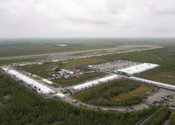 Work progresses on a new migrant detention facility dubbed "Alligator Alcatraz," at Dade-Collier Training and Transition facility in the Florida Everglades, Friday, July 4, 2025, in Ochopee, Fla. (AP Photo/Rebecca Blackwell)