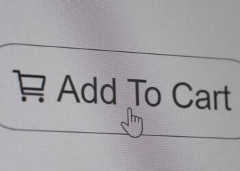 Pressing add to cart button on the computer screen. Close up.