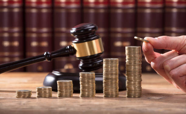 Close-up Of Human Hand Placing A Coin On Increasing Stacked Coins
