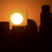 The sun sets behind highrise buildings in downtown Los Angeles, California on September 30, 2020. - A heat advisory is in effect for southern California as temperatures hit triple-digits this week with potential for stress on the power grid causing power outages or rolling blackouts. (Photo by Frederic J. BROWN / AFP) (Photo by FREDERIC J. BROWN/AFP via Getty Images)