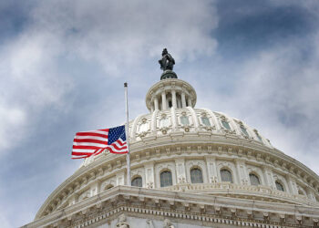 An American flag flies at half mast over U.S. Capitol Building.