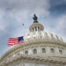 An American flag flies at half mast over U.S. Capitol Building.