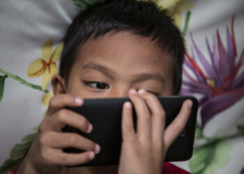 Photo taken in Bogor, Indonesia on 25 September 2016 show A child looking for internet on mobile phone. Story of Darkside of Internet cause to Children Story. Gang rape case at Bengkulu-Sumatera that killed a young girl by 14 boys is one of example tips of ice berg of mountain ice effect about Internet effect to the Sexual harrasment to child case in Indonesia.Internet Sehat Indonesia, an NGO for healthy internet in Indonesia reported that number of internet users in Indonesia from 2011-2014 increase significantly because of the infrastructure
for internet connection in Indonesia from BTS by Telecommunication company and fiber optic, in total of 252,4 Million of Indonesian people, 88,1 million using Internet and with 49% of them are age 8-25 years old. Mrs. Rita from Indonesian Child Protection of Commission (KPAI) explain that the number
of children using internet effect significantly to the number case of sexual harrasment case, in 2015 reported total 463 case of case Pornograph and cyber crime, which increase 69% from 2014 with 322 case."But this is just what we have, because sexual harrasment case is not always reportable case since the parents feel shame with it",  Mrs. Rita Explain. Mrs. Neneng Handayani, chief of PSMP Handayani, a child protection house for children with law problem add that PSMP Handayani for the past 5 years receive increasing number of sex abuse case. Internet on one sid can give good information but on the other side can give bad effect on children, parents involvement are highly needed to prevent further case sex abuse by internet happening again. 

 (Photo by Donal Husni/NurPhoto via Getty Images)